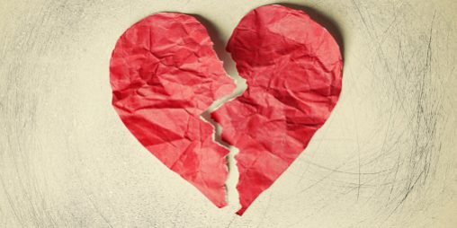 Heart form in red on a crumpled paper background